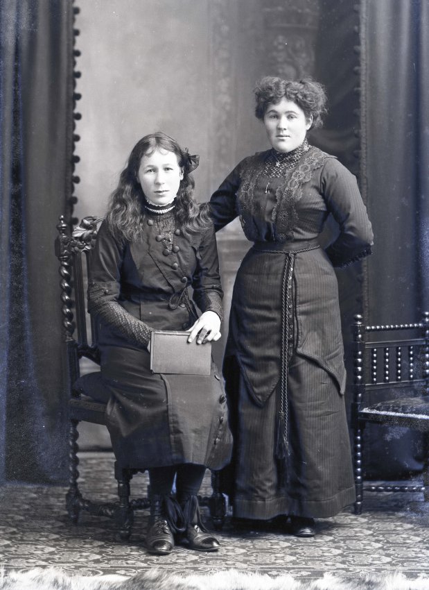 Two women wearing mourning attire